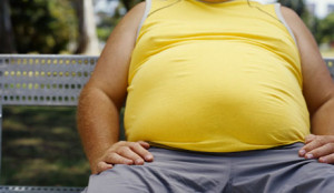 mid section view of a man sitting on a bench in a park