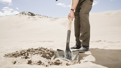 Man digging in desert